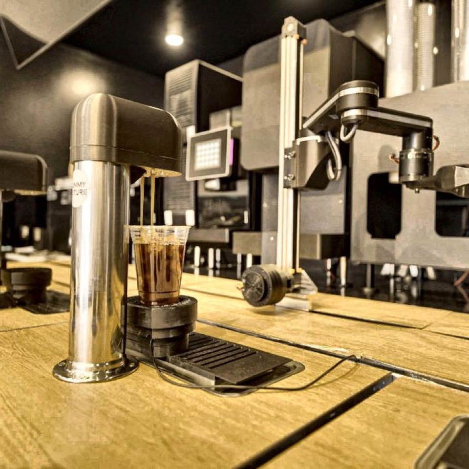 The robot pouring two iced coffees